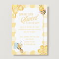 Baby shower invitation with bees and honeycomb design on a white background